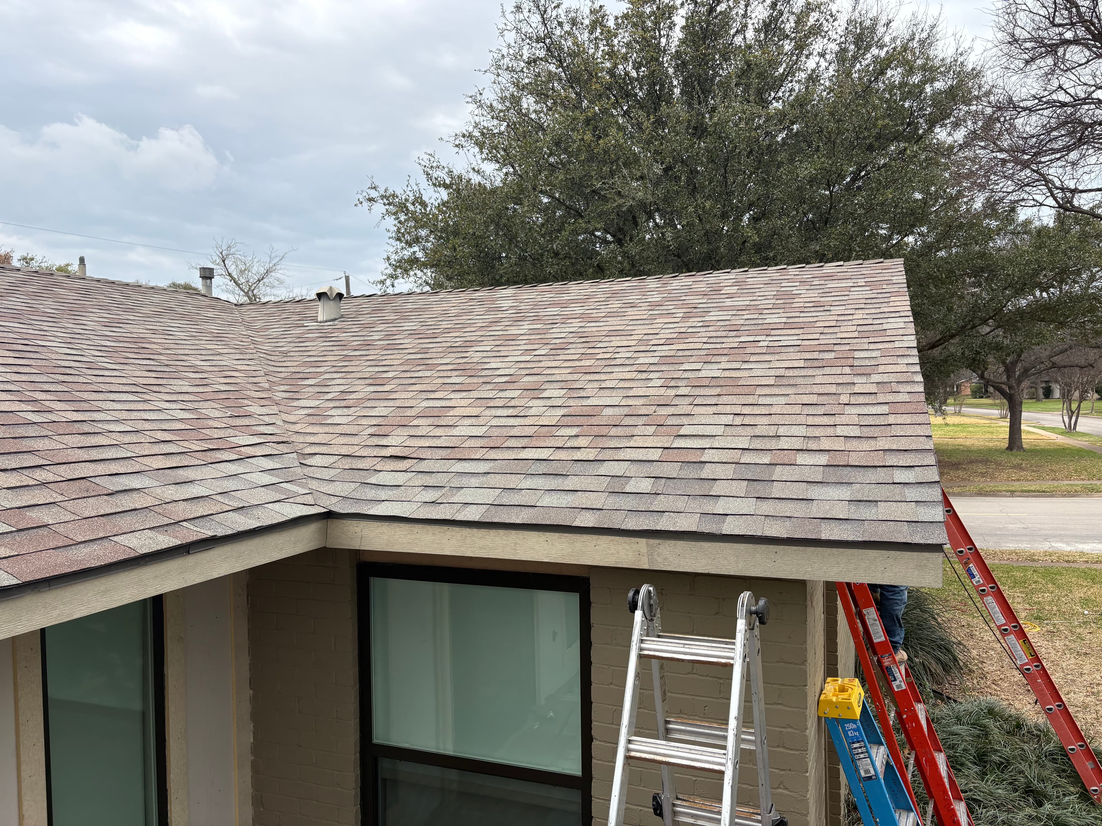 After photo of completed Dallas roofline repair and paint.